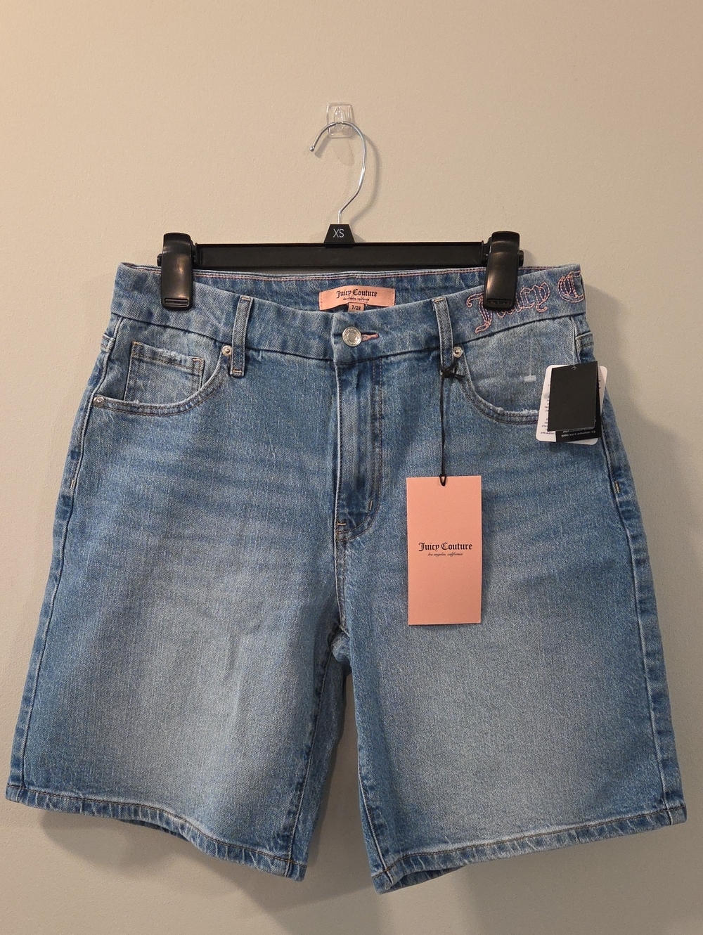 Light-wash denim shorts by Juicy Couture featuring a classic mid-rise